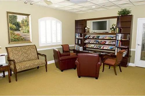 The waiting room at Tampa Dental, with reading and a television.